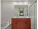 Bright bathroom with double sinks, bathtub, and glass-enclosed shower stall at 2302 N Central Ave # 206, Phoenix, AZ 85004