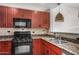 Updated kitchen showcasing modern appliances, granite countertops, and custom cabinetry at 2302 N Central Ave # 206, Phoenix, AZ 85004