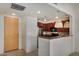 Open-concept kitchen with stylish pendant lighting, modern appliances, and a convenient breakfast bar at 2302 N Central Ave # 206, Phoenix, AZ 85004