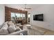 Inviting living room features a brick fireplace, modern ceiling fan, and views of the water at 2302 N Central Ave # 206, Phoenix, AZ 85004