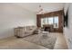 Spacious living room featuring comfortable seating, a modern ceiling fan, and a beautiful brick fireplace at 2302 N Central Ave # 206, Phoenix, AZ 85004