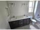 Bathroom featuring double sinks with granite counters, and a tiled shower and tub combination at 24183 N 196Th Ln, Surprise, AZ 85387