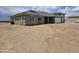 Side view of house with gray tile roof, stone accents and spacious two-car garage at 24183 N 196Th Ln, Surprise, AZ 85387