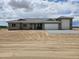 New construction home featuring a gray tile roof, stone accents, and a spacious two-car garage at 24183 N 196Th Ln, Surprise, AZ 85387