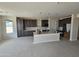 Kitchen featuring dark cabinets, a large island with granite countertops, and stainless steel appliances at 24183 N 196Th Ln, Surprise, AZ 85387