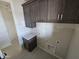 Functional laundry room featuring cabinets above the granite countertop and utility connections at 24183 N 196Th Ln, Surprise, AZ 85387