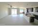 Open-concept living space with tile floors, island kitchen with granite countertops, and patio access at 24183 N 196Th Ln, Surprise, AZ 85387
