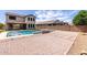 Expansive backyard featuring a refreshing pool with tanning ledge and ample hardscape at 24733 N 96Th Ln, Peoria, AZ 85383