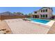 Spacious backyard offers an inviting pool area, turf, and hardscape for outdoor enjoyment at 24733 N 96Th Ln, Peoria, AZ 85383