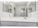 Bright bathroom featuring a vanity with double sinks and a large mirror at 24733 N 96Th Ln, Peoria, AZ 85383
