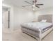 Comfortable bedroom with a decorative bed frame, ceiling fan, and soft lighting at 24733 N 96Th Ln, Peoria, AZ 85383