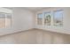 Bright bedroom featuring a view of the pool through three large windows and tile floors at 24733 N 96Th Ln, Peoria, AZ 85383