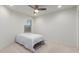 Comfortable bedroom with soft carpet, ceiling fan, and a large window for natural light at 24733 N 96Th Ln, Peoria, AZ 85383