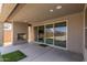 Relaxing covered patio boasts a stone fireplace and seamless access to the backyard pool area at 24733 N 96Th Ln, Peoria, AZ 85383