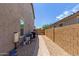 Side view of the home exterior, showing outdoor equipment on gravel at 24733 N 96Th Ln, Peoria, AZ 85383