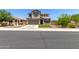 Charming two-story home boasts a well-manicured lawn, complemented by a two-car garage and inviting curb appeal at 24733 N 96Th Ln, Peoria, AZ 85383