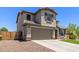 Charming two-story home boasts a well-manicured lawn, complemented by a two-car garage and inviting curb appeal at 24733 N 96Th Ln, Peoria, AZ 85383