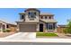 Charming two-story home boasts a well-manicured lawn, complemented by a two-car garage and inviting curb appeal at 24733 N 96Th Ln, Peoria, AZ 85383