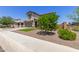 Charming two-story home boasts a well-manicured lawn, complemented by a two-car garage and inviting curb appeal at 24733 N 96Th Ln, Peoria, AZ 85383