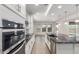 Bright kitchen with island, granite countertops, stainless steel appliances, and natural light at 24733 N 96Th Ln, Peoria, AZ 85383