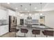Spacious kitchen with island, granite countertops, stainless steel appliances, and barstool seating at 24733 N 96Th Ln, Peoria, AZ 85383