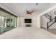 Bright living room features a ceiling fan, neutral carpet, and sliding glass doors that open to the outdoor space at 24733 N 96Th Ln, Peoria, AZ 85383