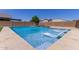 Stunning pool with cascading water feature and tanning ledge with lounge chairs at 24733 N 96Th Ln, Peoria, AZ 85383