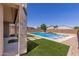Gorgeous backyard pool, turf and hardscape offer a perfect outdoor oasis at 24733 N 96Th Ln, Peoria, AZ 85383