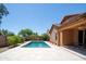 Inviting backyard featuring a sparkling pool, stone patio, grassy area, and lush landscaping at 26633 N 41St Way, Cave Creek, AZ 85331