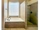 Stylish bathroom featuring a soaking tub, a glass block window and tiled walk-in shower at 26633 N 41St Way, Cave Creek, AZ 85331