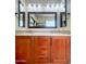 Bathroom vanity featuring dual sinks, framed mirrors and ample storage space in stained wood at 26633 N 41St Way, Cave Creek, AZ 85331