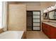 A luxurious bathroom featuring a soaking tub, glass shower and spacious vanity with double sinks at 26633 N 41St Way, Cave Creek, AZ 85331