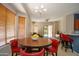 Comfortable dining room area, featuring wood accents, modern chandelier, and backyard access at 26633 N 41St Way, Cave Creek, AZ 85331
