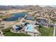 Aerial view of community amenities featuring pool, tennis court, and lake at 30031 N Little Leaf Dr, San Tan Valley, AZ 85143