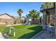Artificial grass backyard with playhouse and mature trees for shade at 30031 N Little Leaf Dr, San Tan Valley, AZ 85143