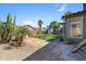 Spacious backyard with artificial grass, desert landscaping, and a charming playhouse at 30031 N Little Leaf Dr, San Tan Valley, AZ 85143