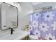 Bright bathroom with modern vanity, and a shower featuring a floral curtain at 30031 N Little Leaf Dr, San Tan Valley, AZ 85143