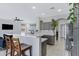 Open-concept kitchen with gray cabinetry, stainless steel appliances, and breakfast bar seating at 30031 N Little Leaf Dr, San Tan Valley, AZ 85143