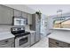Well-lit kitchen featuring stainless steel appliances and light gray cabinetry at 30031 N Little Leaf Dr, San Tan Valley, AZ 85143
