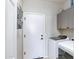 Functional laundry room with washer, dryer, storage cabinets and a door at 30031 N Little Leaf Dr, San Tan Valley, AZ 85143