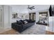 Comfortable living room featuring a large sectional sofa and seamless flow into the kitchen at 30031 N Little Leaf Dr, San Tan Valley, AZ 85143