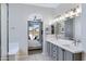 Main bathroom with double sinks, soaking tub, and doorway to the bedroom at 30031 N Little Leaf Dr, San Tan Valley, AZ 85143