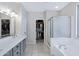 Main bathroom featuring dual vanity, soaking tub and walk-in closet at 30031 N Little Leaf Dr, San Tan Valley, AZ 85143