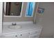 Bathroom featuring a mirror, window, and a white vanity at 303 S Recker Rd # 247, Mesa, AZ 85206