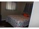 Comfortable bedroom featuring a window and patterned bedding at 303 S Recker Rd # 247, Mesa, AZ 85206