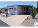 Charming home with a covered parking area, desert landscaping and exterior decorations at 303 S Recker Rd # 247, Mesa, AZ 85206