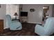 Cozy living room featuring wood-look floors and comfortable recliners at 303 S Recker Rd # 247, Mesa, AZ 85206