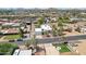 An aerial view of the home showcasing its well-kept landscaping, detached garage, and proximity to neighborhood amenities at 3043 E Hartford Ave, Phoenix, AZ 85032