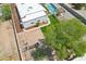 Overhead shot shows a house with a pool, detached garage, green turf, and a swing set in the backyard at 3043 E Hartford Ave, Phoenix, AZ 85032
