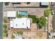 Aerial view showcasing the home's layout, pool, landscaped backyard, and surrounding neighborhood at 3043 E Hartford Ave, Phoenix, AZ 85032